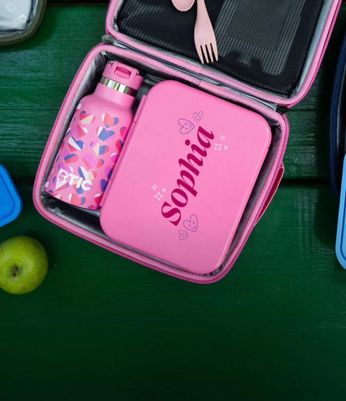 Pink insulated lunch bag with a personalized lunch container, patterned RTIC water bottle, and reusable utensils.